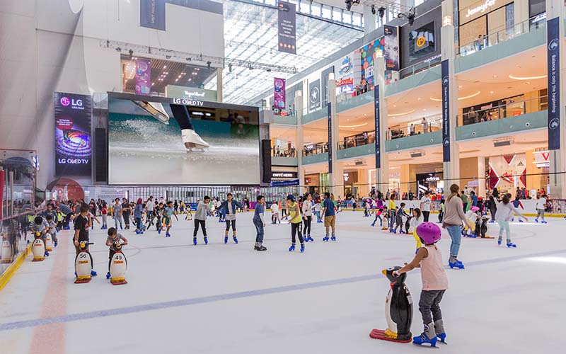 Kids and visitors enjoying ice skating at Dubai Ice Rink, a popular indoor attraction for fun and recreation.