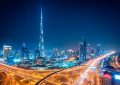 Night view of Dubai Downtown in April with Burj Khalifa and glowing cityscape