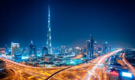 Night view of Dubai Downtown in April with Burj Khalifa and glowing cityscape