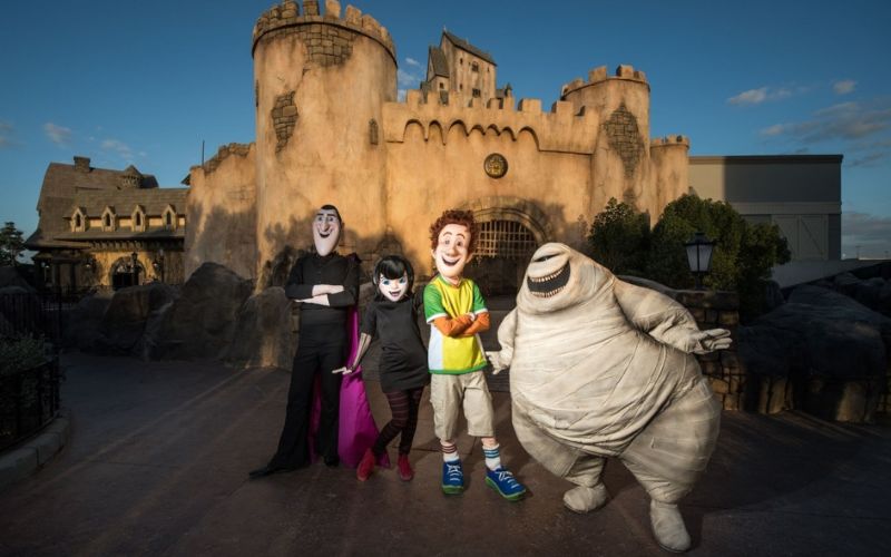 Hotel Transylvania characters posing in front of a spooky castle-themed backdrop at Motiongate Dubai during Halloween celebrations.