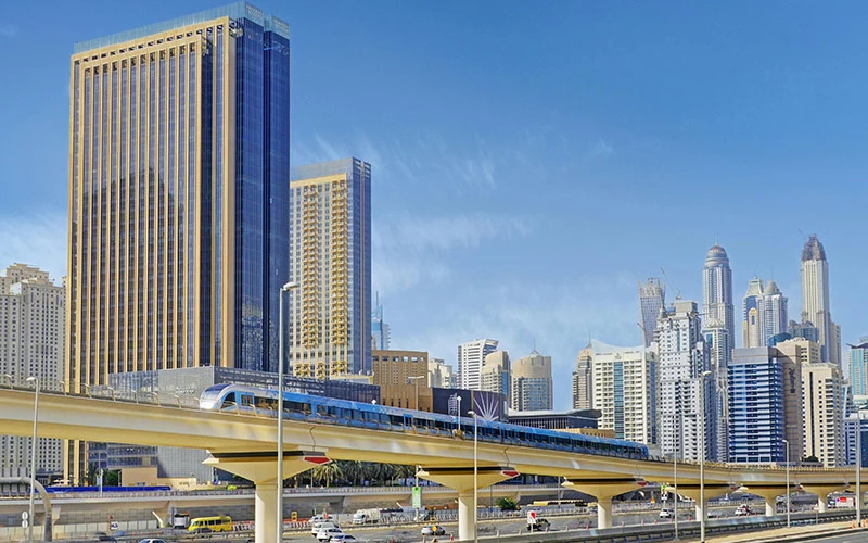 Dubai Metro with high-rise buildings in the city background