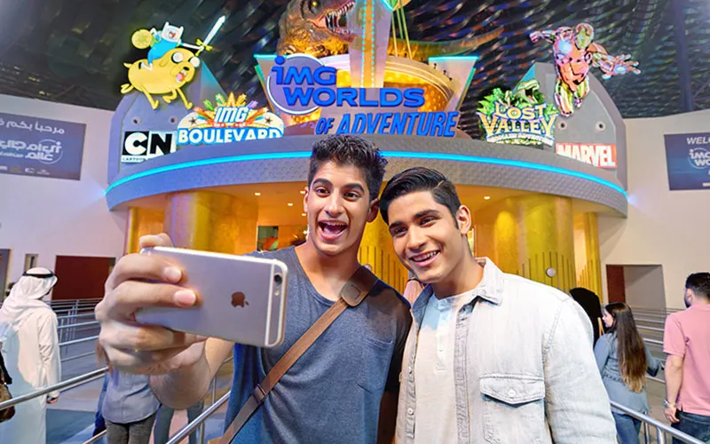 Visitors taking a selfie in front of IMG Worlds of Adventure